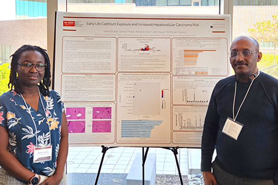 Ph.D. student Velma Shang, left, and NIEHS grantee Dereje Jima in front of poster